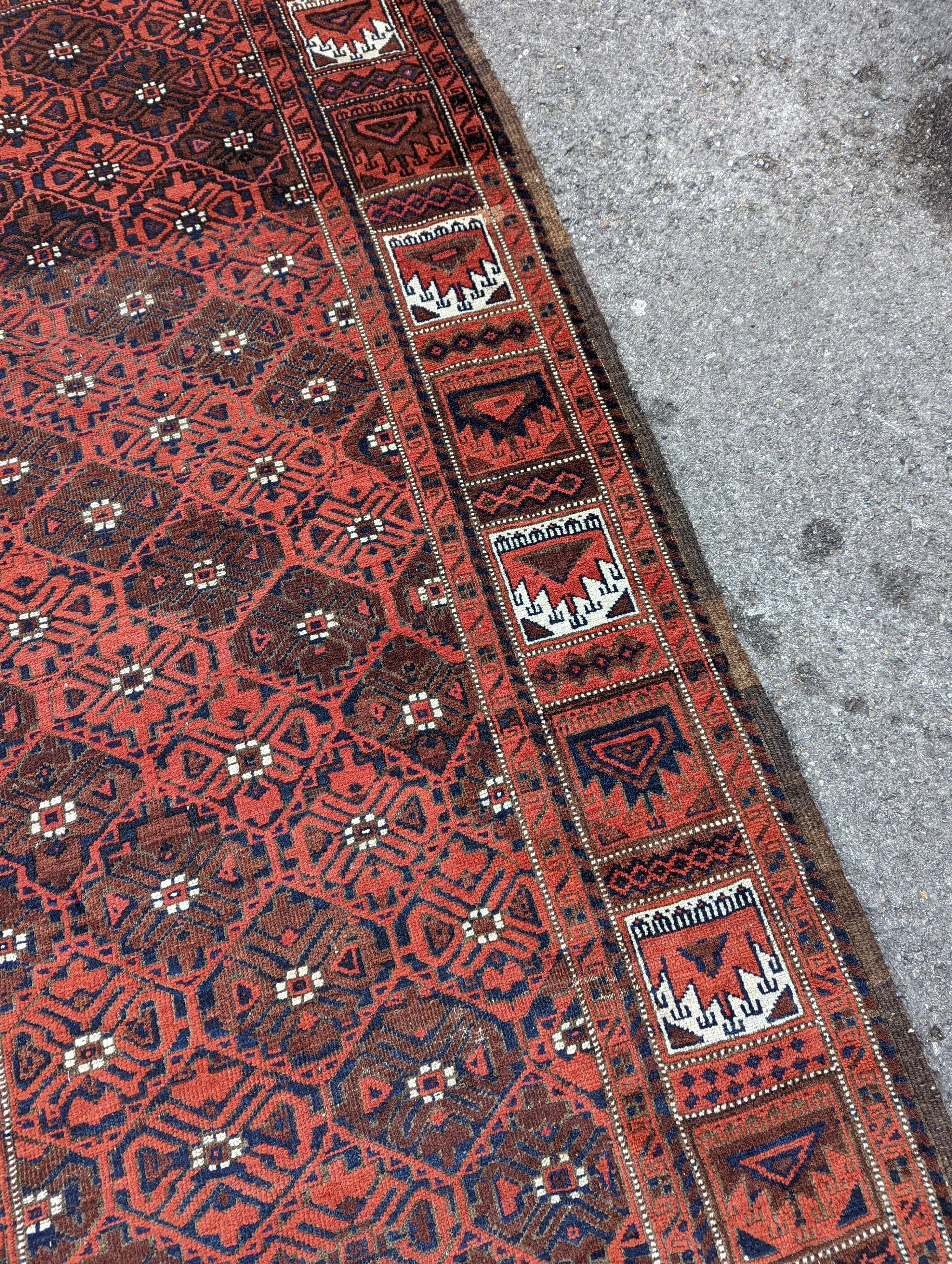 A Turkish red ground rug, 212 x 106cm